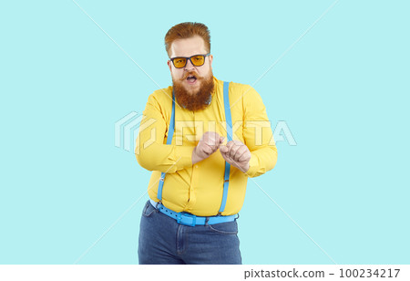 Funny cool stylish bearded fat man dancing victory dance isolated on light blue background. 100234217