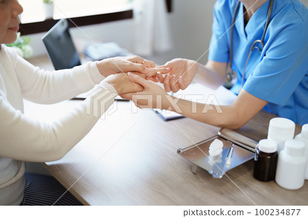 Portrait of a female doctor holding a patient clipboard to discuss and analyze wrist and finger pain 100234877