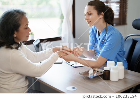 Portrait of a female doctor holding a patient clipboard to discuss and analyze wrist and finger pain 100235154