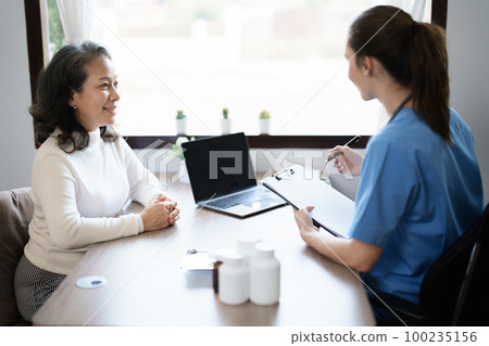 Portrait of a female doctor holding a patient clipboard to discuss and analyze the patient's condition before treating 100235156