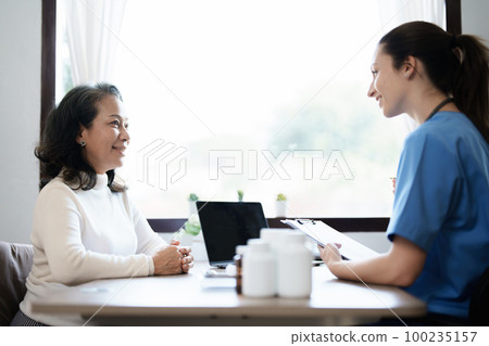 Portrait of a female doctor holding a patient clipboard to discuss and analyze the patient's condition before treating 100235157
