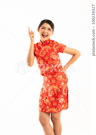 young asian woman in red cheongsam standing pointing her forefinger young asian woman in red cheongsam standing pointing her forefinger 100239327