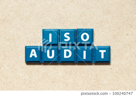 Tile alphabet letter in word ISO audit on wood background Tile alphabet letter in word ISO audit on wood background 100240747