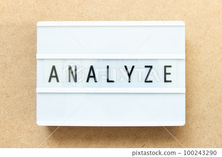 Lightbox with word analyze on wood background 100243290