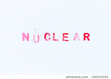 Red color ink rubber stamp in word nuclear on white paper background 100243303