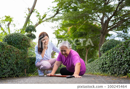 Asian senior woman fell down on lying floor because faint and limb weakness and Crying in pain form accident and her daughter came to help support. Concept of old elderly insurance and health care Asian senior woman fell down on lying floor because faint and limb weakness and Crying in pain form accident and her daughter came to help support. Concept of old elderly insurance and health care 100245464