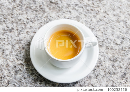 Cup of coffee on a grey stone table Cup of coffee on a grey stone table 100252556