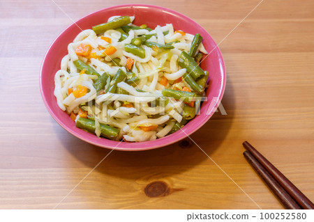 Udon noodles with vegetables on wooden table. Japanese cuisine. Asian food Udon noodles with vegetables on wooden table. Japanese cuisine. Asian food 100252580