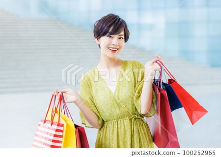 Young woman enjoying shopping at a shopping center Young woman enjoying shopping at a shopping center 100252965