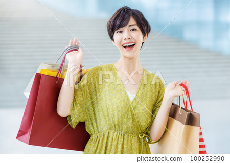 Young woman enjoying shopping at a shopping center Young woman enjoying shopping at a shopping center 100252990