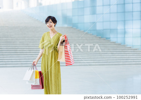 Young woman enjoying shopping at a shopping center Young woman enjoying shopping at a shopping center 100252991