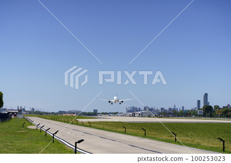 Airport runway with a plane taking off. Travel, transport, business concept Airport runway with a plane taking off. Travel, transport, business concept 100253023