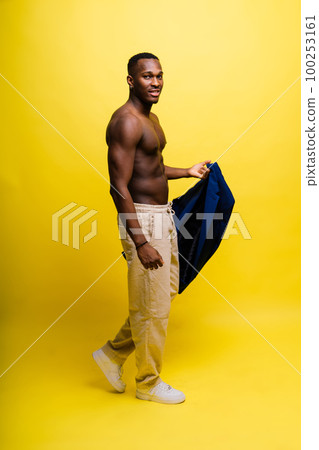 Young african man standing shirtless with a happy and cool smile on face. lucky person. 100253161