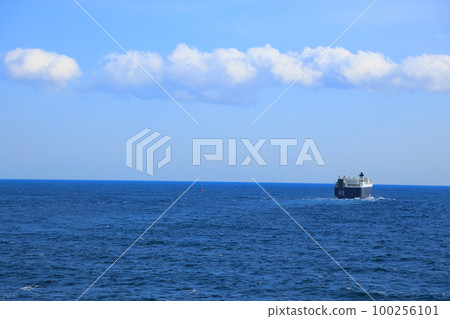 A cargo ship sailing quietly on calm seas 100256101