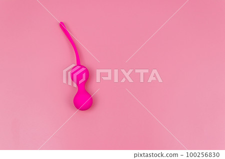 Ben Wa balls or Geisha balls on pink background. Pink double vaginal balls Ben Wa balls or Geisha balls on pink background. Pink double vaginal balls 100256830