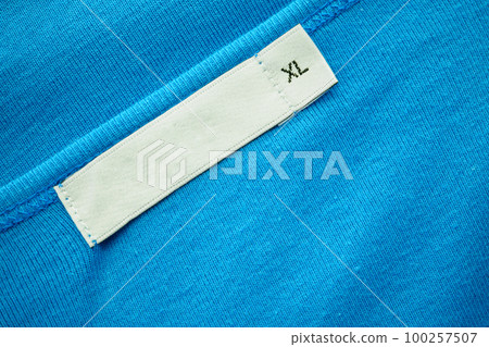 Blank white clothes tag label with XL size on new blue shirt Blank white clothes tag label with XL size on new blue shirt 100257507