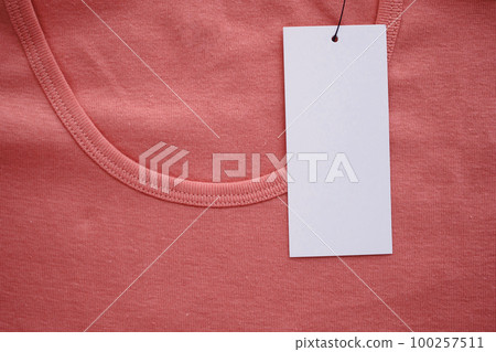 Blank white clothes tag label on new shirt Blank white clothes tag label on new shirt 100257511