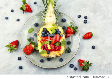 Making fruit salad in pineapple. Making fruit salad in pineapple. 100258397