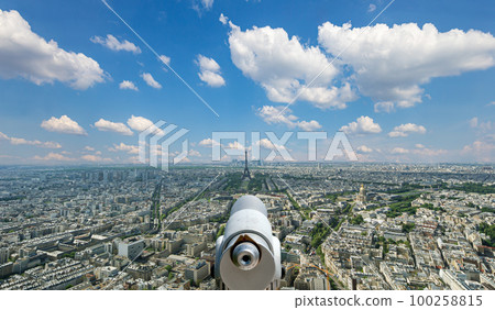 Telescope viewer and city skyline at daytime (against the background of very beautiful clouds). Paris, France.  100258815