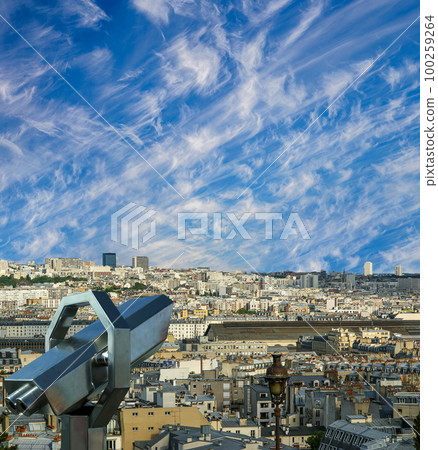 Telescope viewer and city skyline at daytime (against the background of very beautiful clouds). Paris, France. 100259264