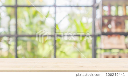 Empty wood table top with abstract blur coffee shop or cafe restaurant background with bokeh light for montage product display 100259441