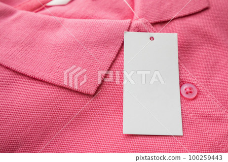 Blank white clothes tag label on new shirt 100259443