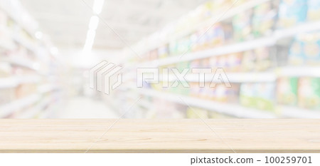 Empty wood table top with abstract supermarket grocery store aisle blurred defocused background with bokeh light for product display 100259701