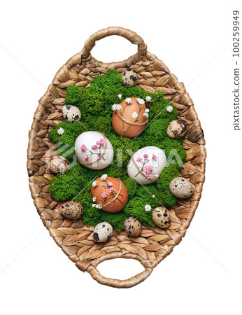 Wicker basket with Easter eggs, natural flowers decor and moss cut out. 100259949