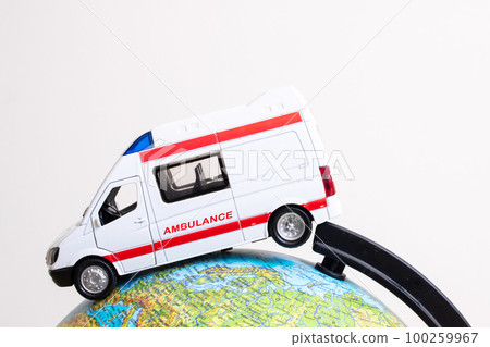 Globe and ambulance toy car on gray background Globe and ambulance toy car on gray background 100259967