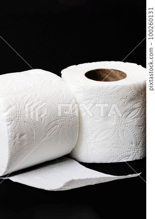 Two rolls of toilet paper on black background Two rolls of toilet paper on black background 100260131