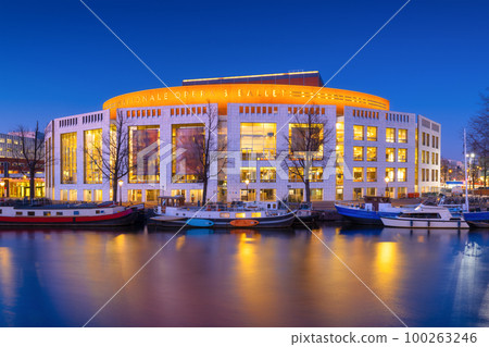 Amsterdam, Netherlands. Opera and Ballet Building. Evening cityscape. Blue sky and city lights. Amsterdam, Netherlands. Opera and Ballet Building. Evening cityscape. Blue sky and city lights. 100263246