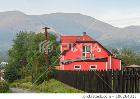 House in village under Lysa Hora in Beskid mountains, in summer morning, Czech republic. House in village under Lysa Hora in Beskid mountains, in summer morning, Czech republic. 100264315
