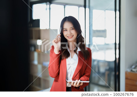 business owner or Asian female marketers are using tablet computer in office work. 100267676