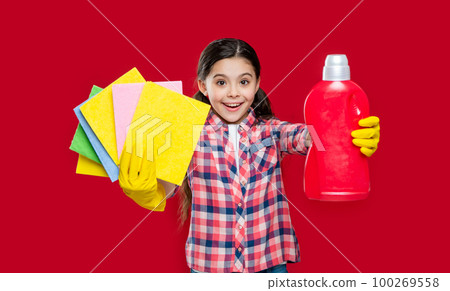 girl with softener detergent isolated on red, selective focus. girl with softener detergent 100269558