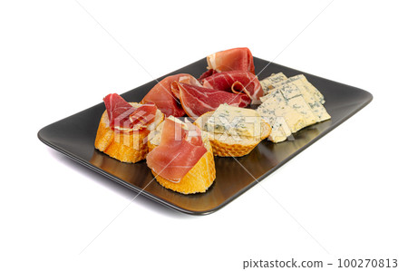 Prosciutto Tapas and Mold Cheese on Black Plate, Spanish Jamon Slices, Parma Ham, Sliced Serrano, Iberico Prosciutto Tapas and Mold Cheese on Black Plate, Spanish Jamon Slices, Parma Ham, Sliced Serrano, Iberico 100270813