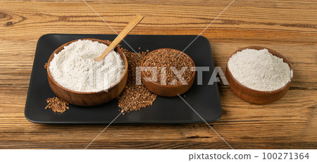 Buckwheat Flour Pile in Wood Bowl, Dry Buck Wheat Powder, Buckwheat Flour on Wooden Rustic Background Buckwheat Flour Pile in Wood Bowl, Dry Buck Wheat Powder, Buckwheat Flour on Wooden Rustic Background 100271364