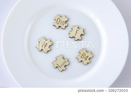 Set of puzzles with five biologically important elements for humans with brown lettering on a white plate. Q10, F, H, Inositol, B4. Set of puzzles with five biologically important elements for humans with brown lettering on a white plate. Q10, F, H, Inositol, B4. 100272033
