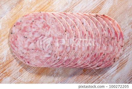 Traditional spanish sausage slices on wooden background closeup 100272205