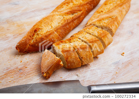Image of cut crunchy homemade baked fresh baguettes Image of cut crunchy homemade baked fresh baguettes 100272334
