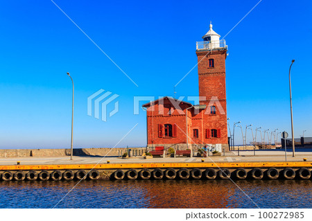 Old brick lighthouse at the Wieprza river mouth to the Baltic Sea in Darlowko, Poland Old brick lighthouse at the Wieprza river mouth to the Baltic Sea in Darlowko, Poland 100272985