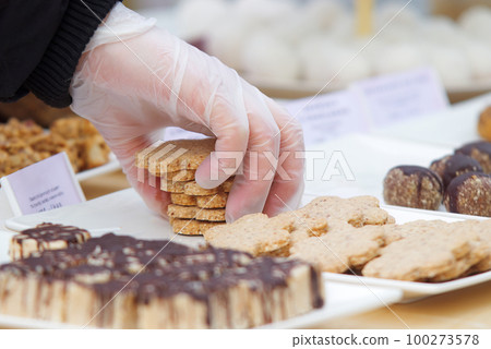Selling homemade cookies in the marketplace. Selling homemade cookies in the marketplace. 100273578