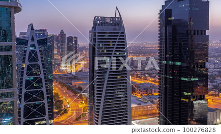 Tall residential buildings at JLT aerial night to day timelapse, part of the Dubai multi commodities centre mixed-use district. 100276828