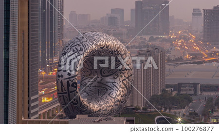 Museum of the Future exhibition space aerial night to day timelapse with iconic torus shape 100276877