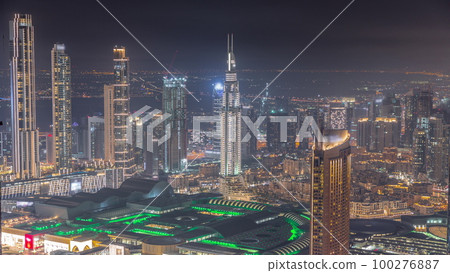 Aerial view of tallest towers in Dubai Downtown skyline and highway night timelapse. Aerial view of tallest towers in Dubai Downtown skyline and highway night timelapse. 100276887