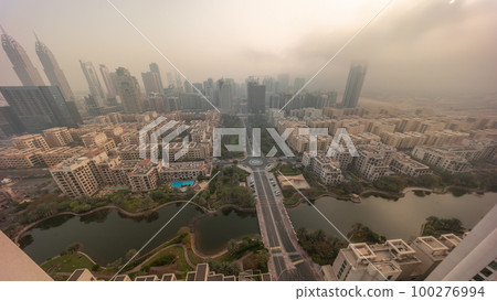 Sunrise over skyscrapers in Barsha Heights district and low rise buildings in Greens district aerial timelapse. Sunrise over skyscrapers in Barsha Heights district and low rise buildings in Greens district aerial timelapse. 100276994