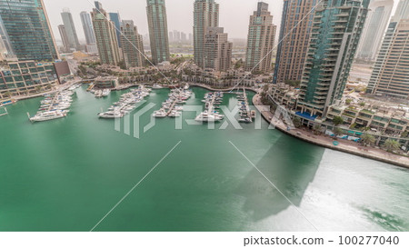 Luxury yacht bay in the city aerial timelapse in Dubai marina 100277040