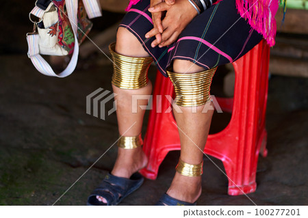 Long Neck tribe woman adorned with rings on her limbs and large ear tunnels Long Neck tribe woman adorned with rings on her limbs and large ear tunnels 100277201