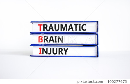 TBI traumatic brain injury symbol. Concept words TBI traumatic brain injury on books on a beautiful white table white background. Medical and TBI traumatic brain injury concept. Copy space. 100277673