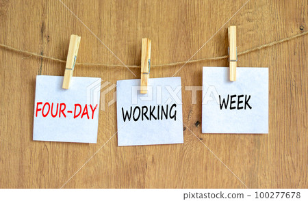 Four-day working week symbol. Concept words Four-day working week on white paper on a beautiful wooden table wooden background. Business and four-day working week concept. Copy space. Four-day working week symbol. Concept words Four-day working week on white paper on a beautiful wooden table wooden background. Business and four-day working week concept. Copy space. 100277678