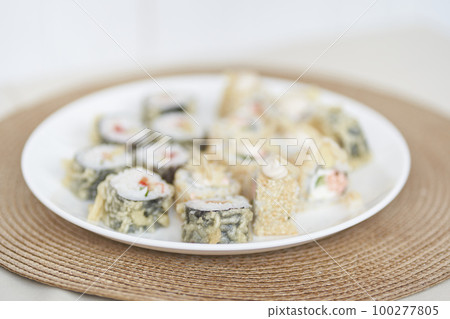 Selective focus on Japanese sushi rolls with raw fish. Delicious rolls are on the plate. Delicious rolls with tofu and vegetables. With space to copy. High quality photo 100277805